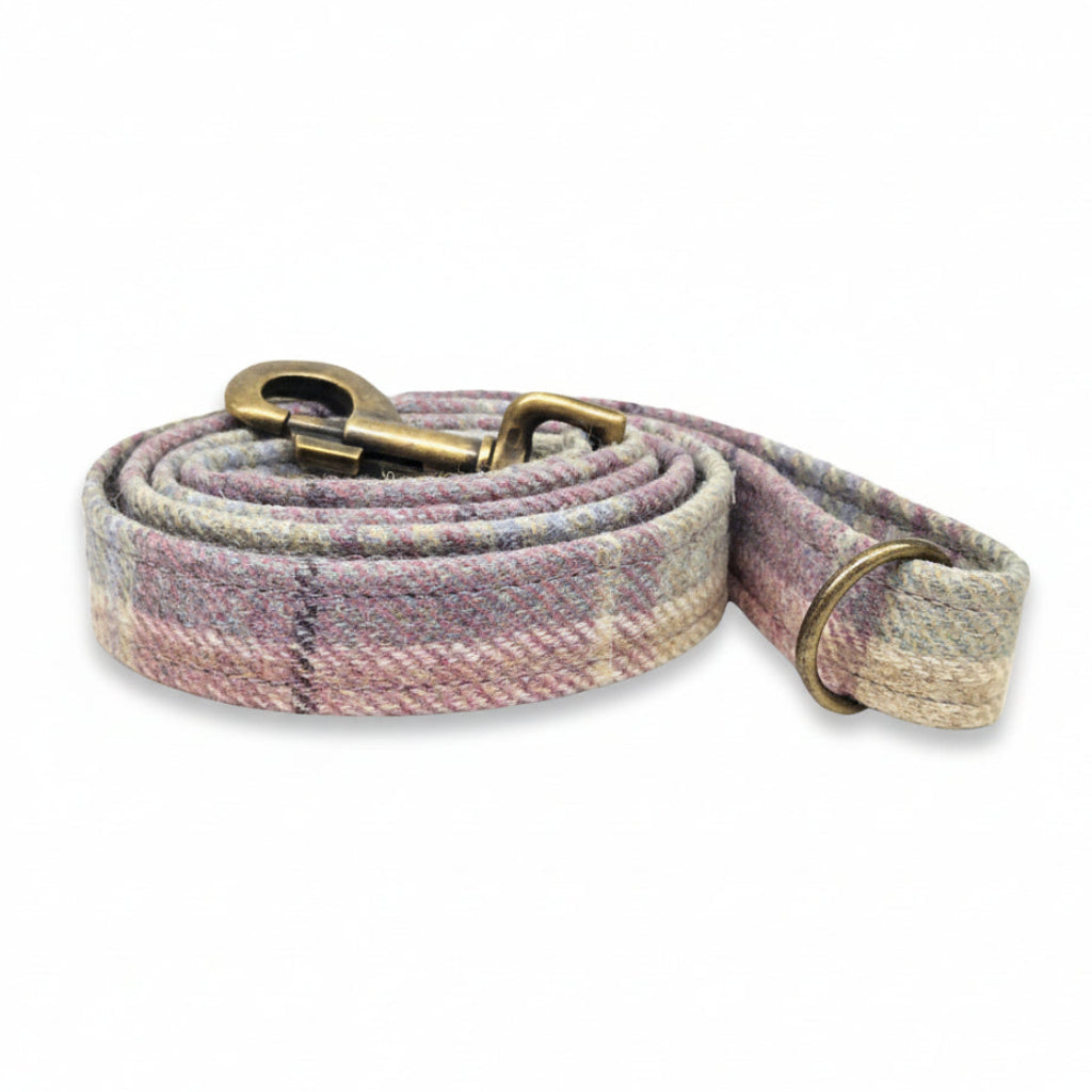 tweed dog leash with pink and beige plaid pattern on a white background