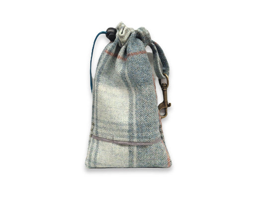 tweed dog treat bag with built in poop dispenser on white background