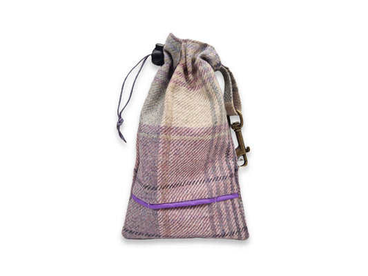 Plaid drawstring dog treat bag with a purple zipper on a white background