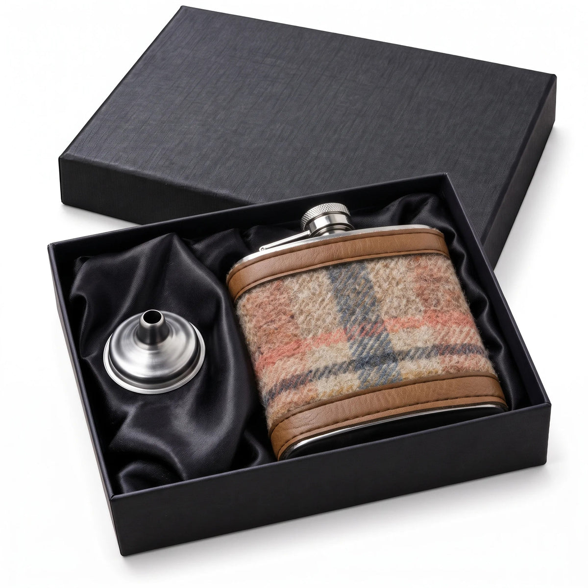 Wool covered hip flask gift set with black gift box and funnel by a fireplace and Christmas tree