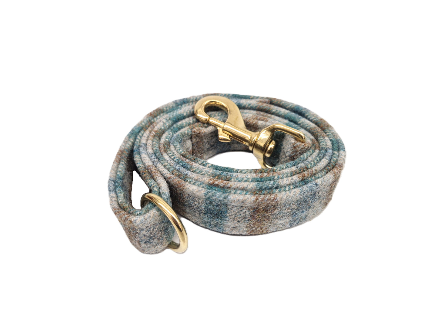 A coiled fabric pet leash with a textured, woven plaid pattern in shades of blue, gray, and brown, featuring brass hardware including a swivel snap hook and D-ring, set against a plain white background.