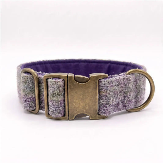 A woven harris tweed dog collar with a textured purple and gray pattern, featuring an antique bronze buckle and a solid purple fabric lining, shown on a white background.