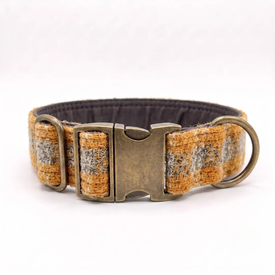 A woven extra wide tweed dog collar with a textured pattern of yellow, gray, and white threads, featuring an antique bronze metal buckle and D-ring, shown on a white background.