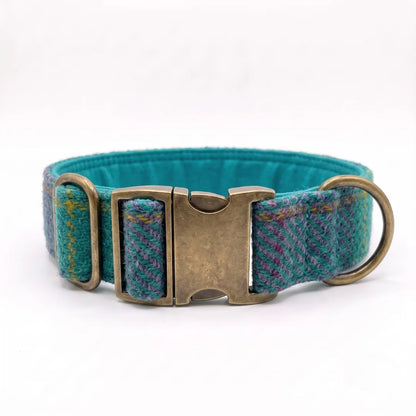 A teal and multicolor tweed dog collar with an antique bronze metal buckle and a brass ring, shown on a plain white background.