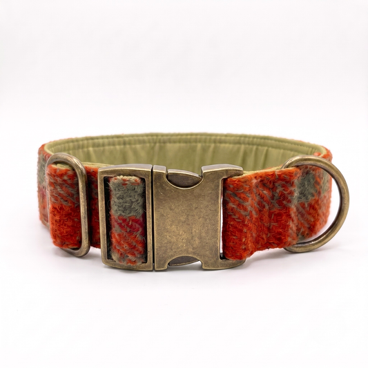 A 38mm wide dog collar with a textured red and orange plaid pattern, olive green fabric lining, and an antique bronze metal buckle and hardware, shown on a white background.