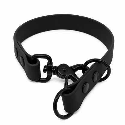 A matte black biothane collar with a matching black metal swivel snap closure and two attached black metal O-rings, shown on a plain white background.