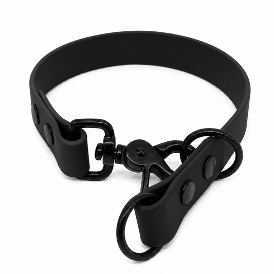 A matte black biothane collar with a matching black metal swivel snap closure and two attached black metal O-rings, shown on a plain white background.