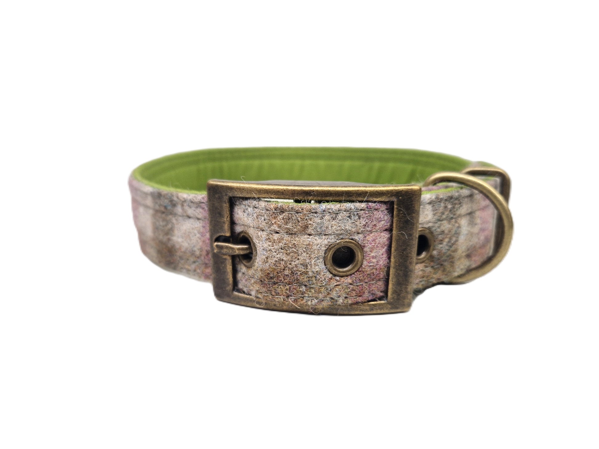 A dog collar with a distressed, weathered bronze buckle and hardware, featuring a textured pattern of brown, beige, and pink tones, with a bright green fabric lining visible on the inside.