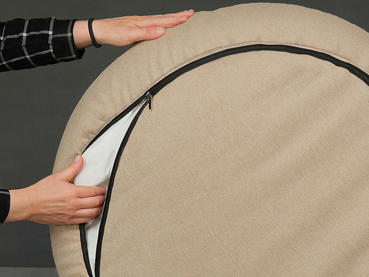 Underside view showing the zip on the Beige Deluxe Cocoon Dog Bed by Collared Creatures