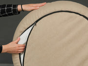 Underside view showing the zip on the Beige Deluxe Cocoon Dog Bed by Collared Creatures
