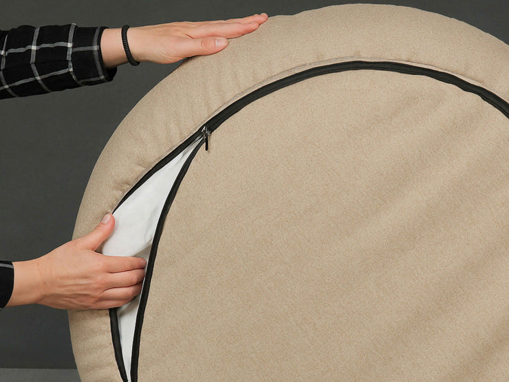 Underside view showing the zip on the Beige Deluxe Cocoon Dog Bed by Collared Creatures