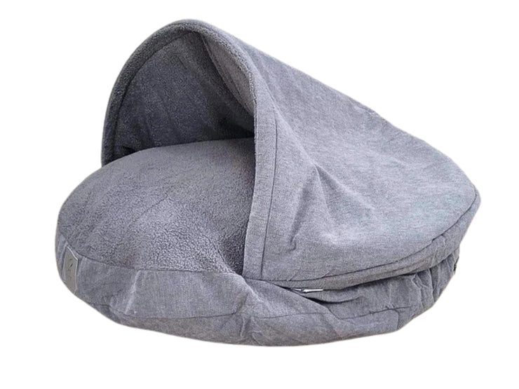 Grey dog cave bed with raised hood and plush lining on white background