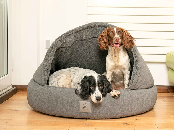 wo dogs relaxing inside a Grey Deluxe Comfort Cocoon Dog Bed with fleece lining by Collared Creatures