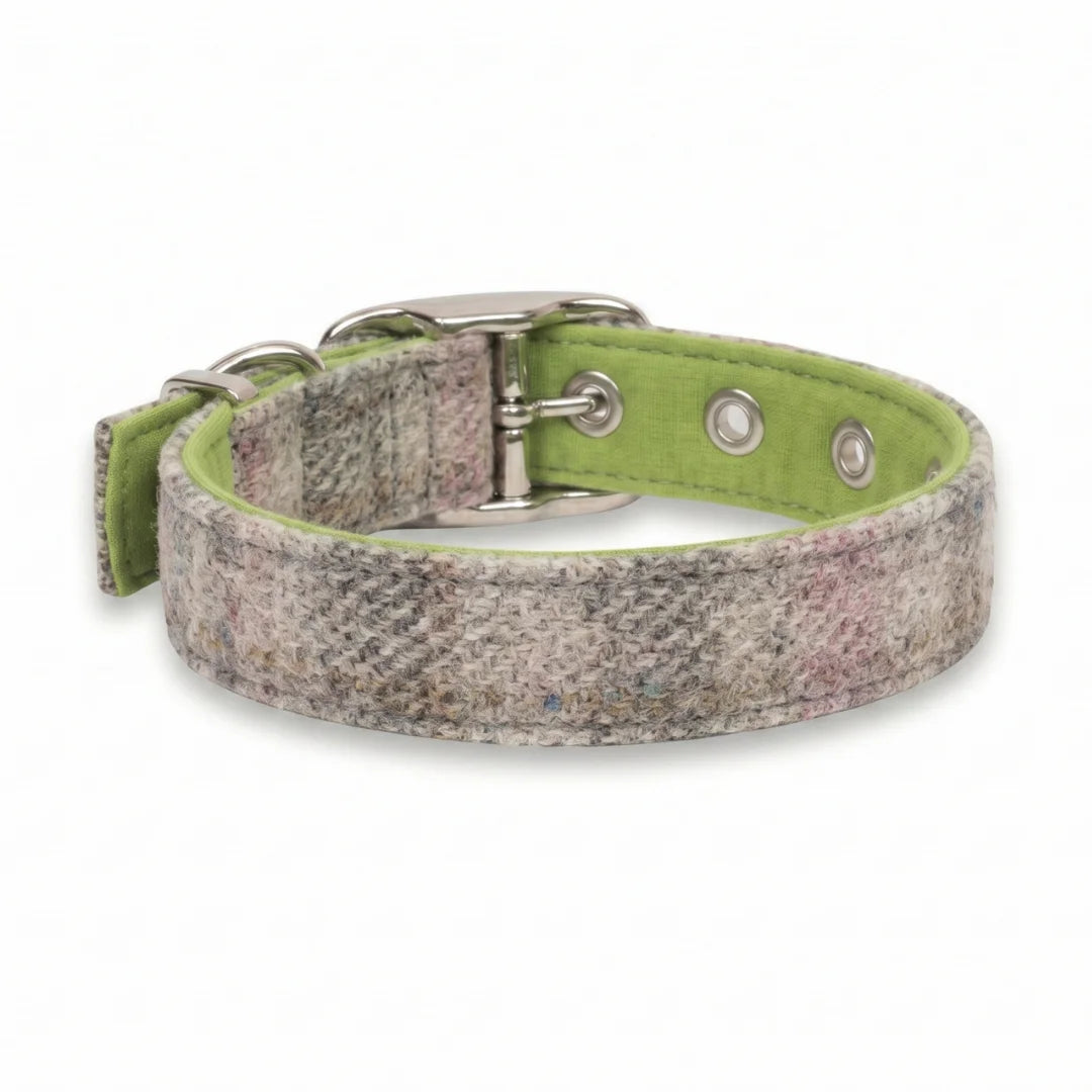A woven dog collar with a textured multicolor plaid pattern in gray, beige, and pink, featuring a bright lime green inner lining and silver-tone metal hardware.