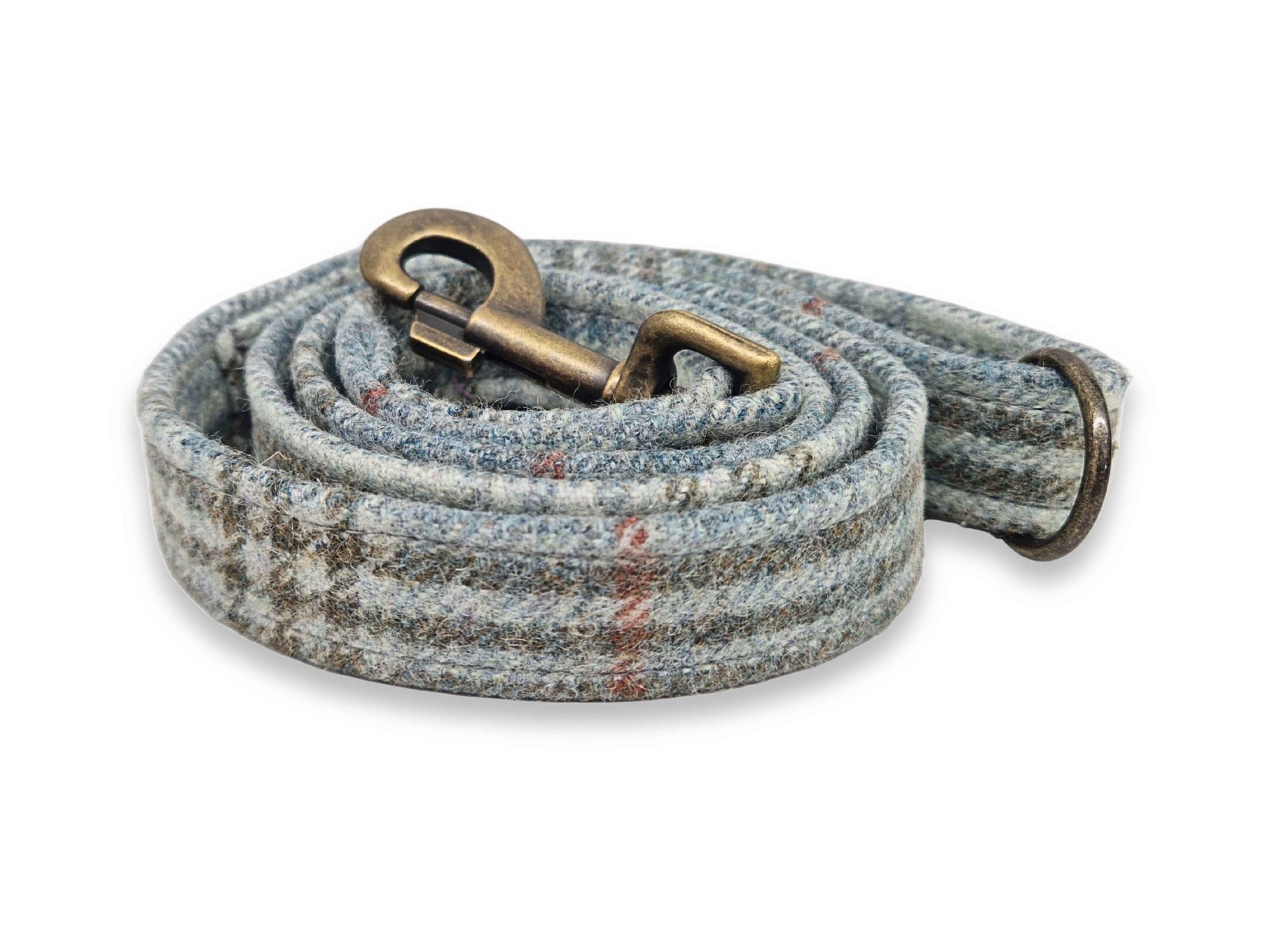 Dog leash with a textured tweed pattern and brass snap hook on a white background