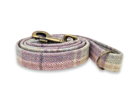tweed dog leash with pink and beige plaid pattern on a white background