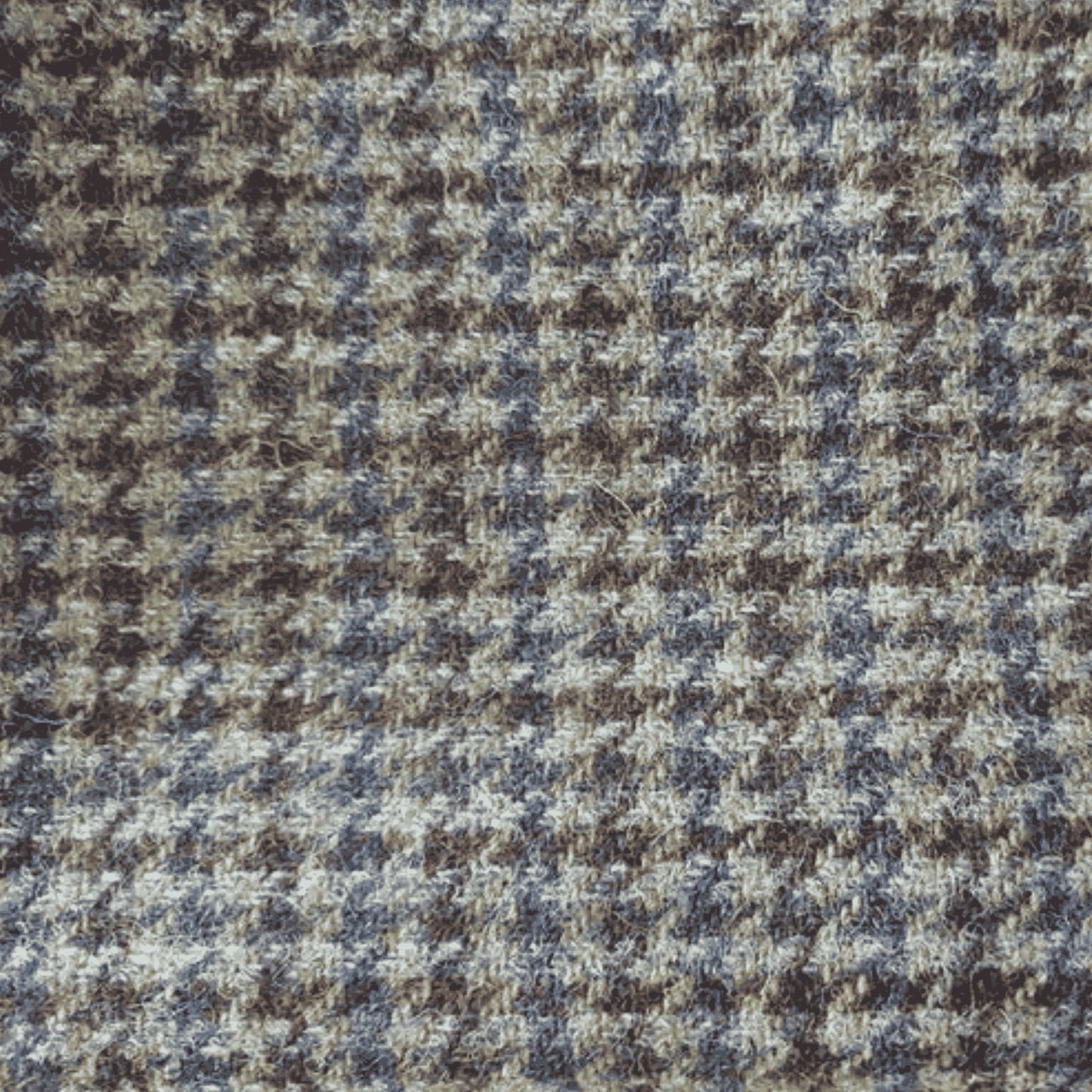 Close-up of a houndstooth pattern fabric with brown and blue colors.
