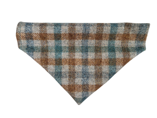 A triangular dog bandana made of a textured wool-like fabric with a plaid pattern in brown, teal blue, and off-white.