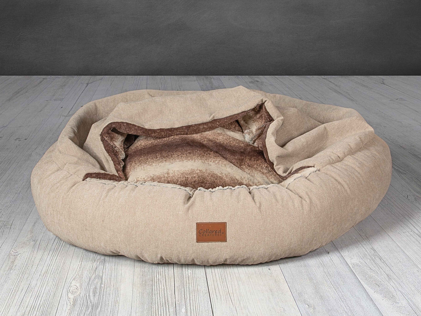 Collared Creatures Beige classic cocoon dog bed with soft faux fur lining and open cover