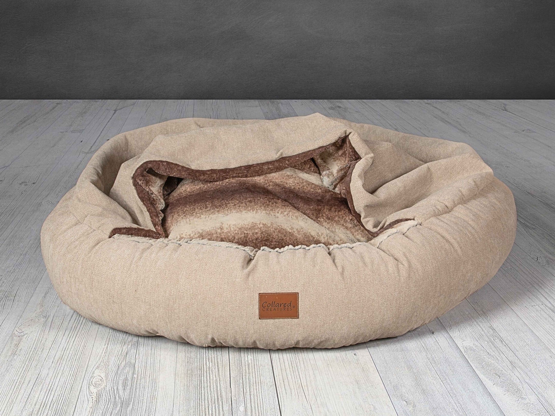 Collared Creatures Beige classic cocoon dog bed with soft faux fur lining and open cover