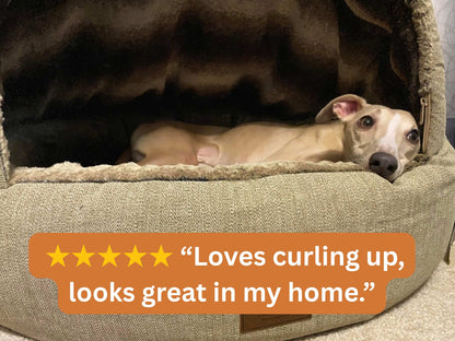 Whippet lying inside a beige deluxe cocoon dog bed with a five-star rating text overlay.