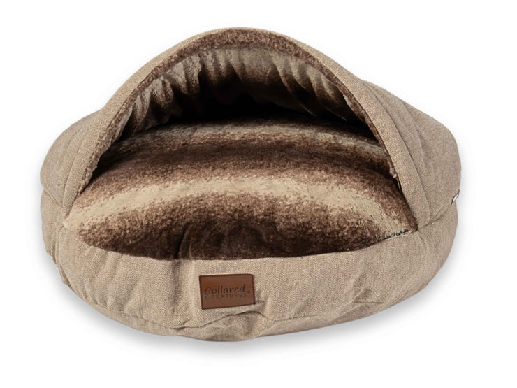 Close-up of beige dog cave bed showing open hood and plush interior - Collared Creatures