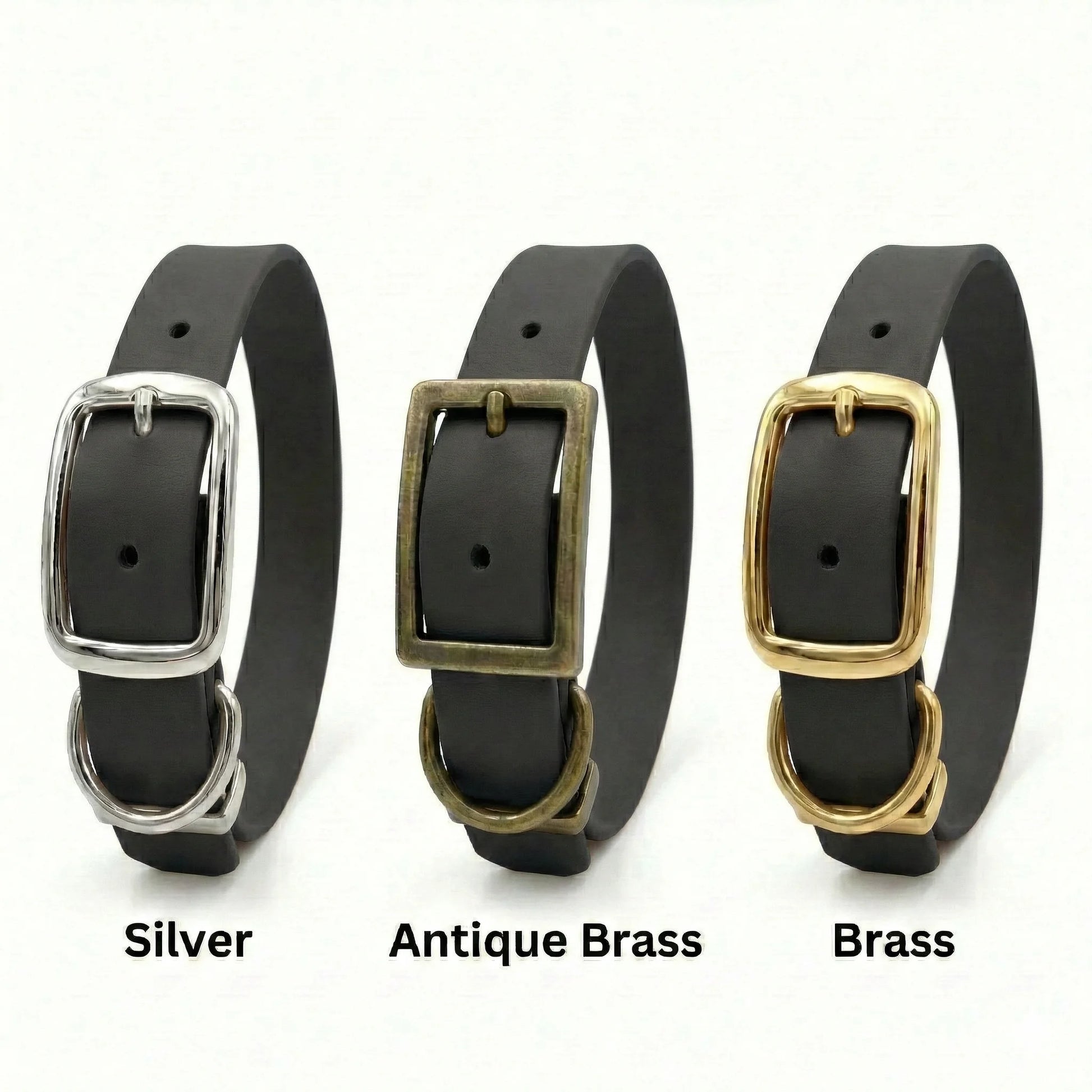 Three  black biothane dog collars with silver, antique brass, and brass buckles on a white background.