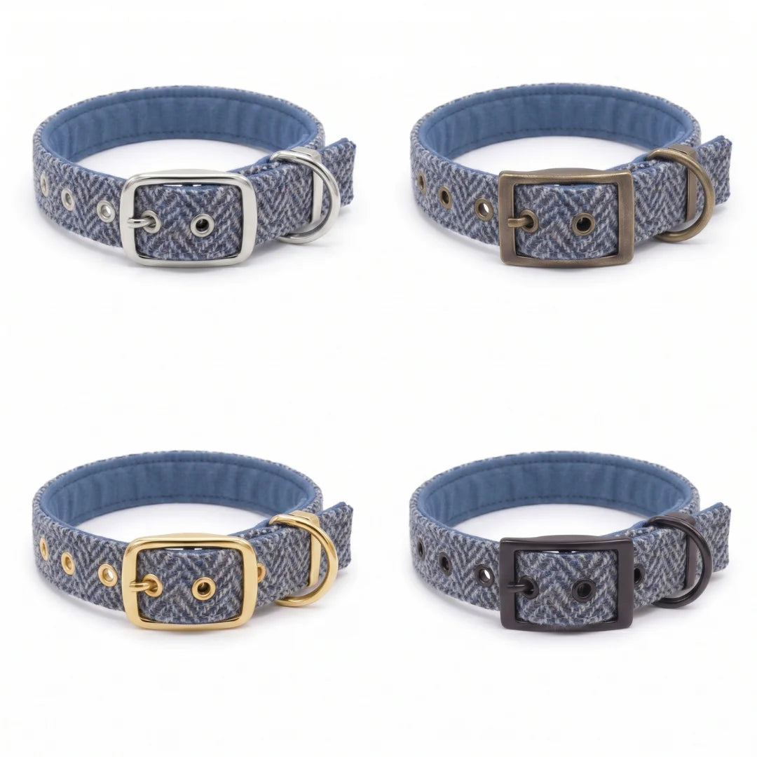 Four dog collars with blue herringbone-patterned fabric and silver-toned metal hardware, arranged in a 2x2 grid on a white background.