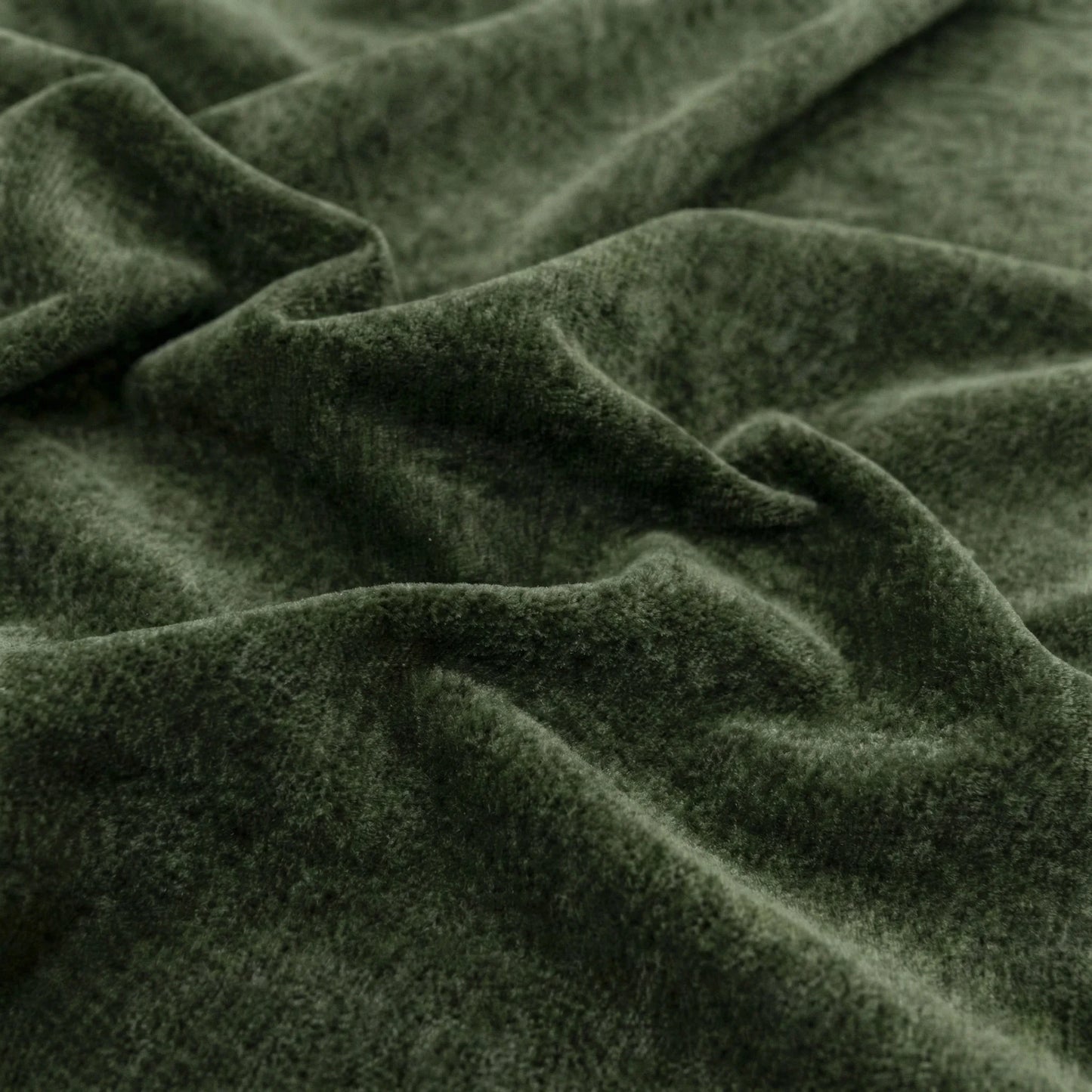 Close-up of dark green fabric with visible texture