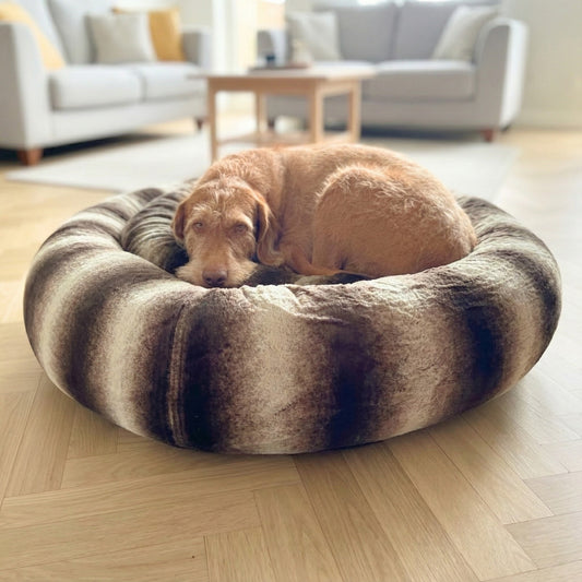 dog resting in brown and beige anti-anxiety donut dog bed by collared creatures
