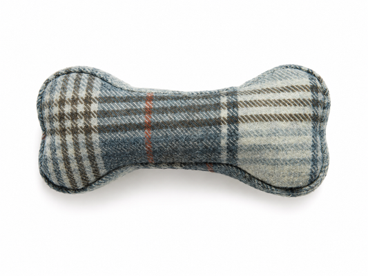 A bone-shaped dog toy made of blue-gray and beige plaid wool fabric, shown on a clean white background.