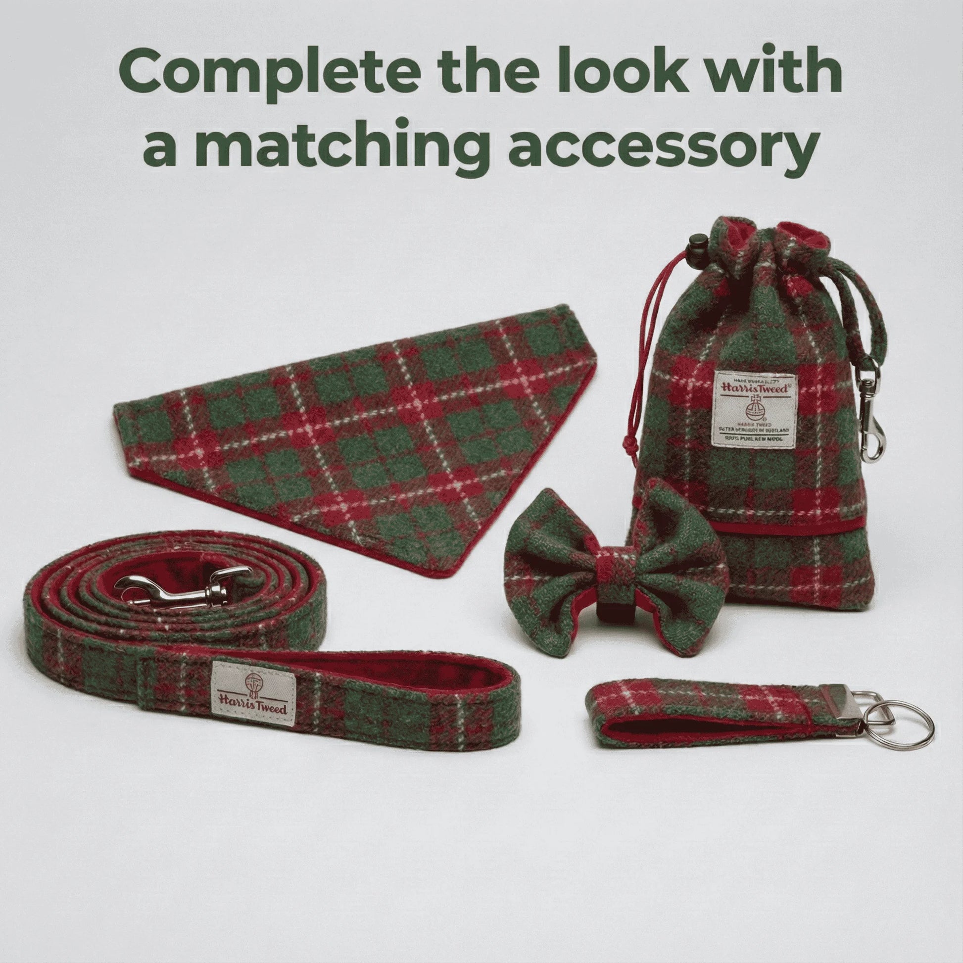 Set of red and green plaid pet accessories including a collar, leash, bow tie, and pouch on a white background.