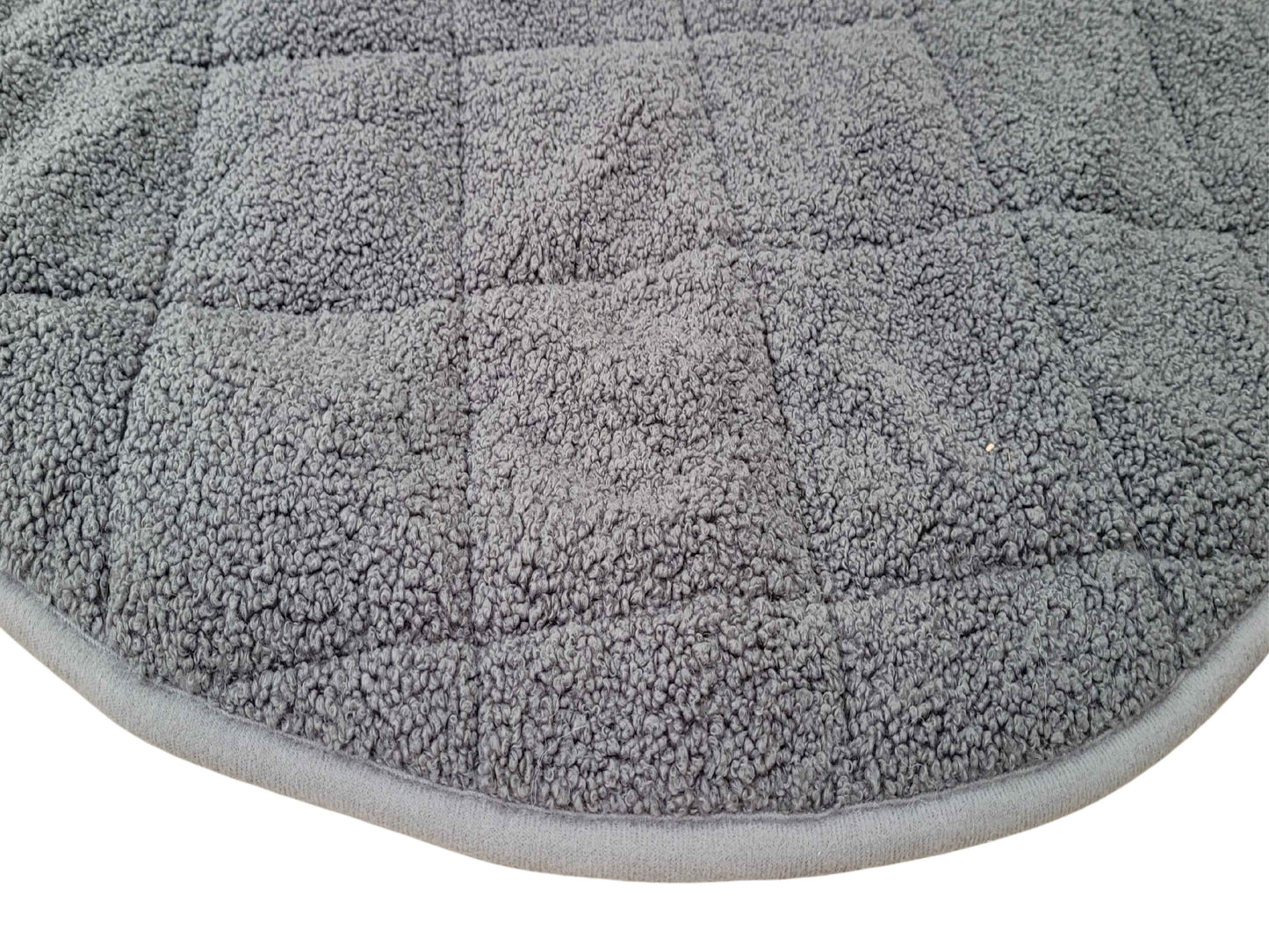 close up of grey round teddy fur dog bed blanket