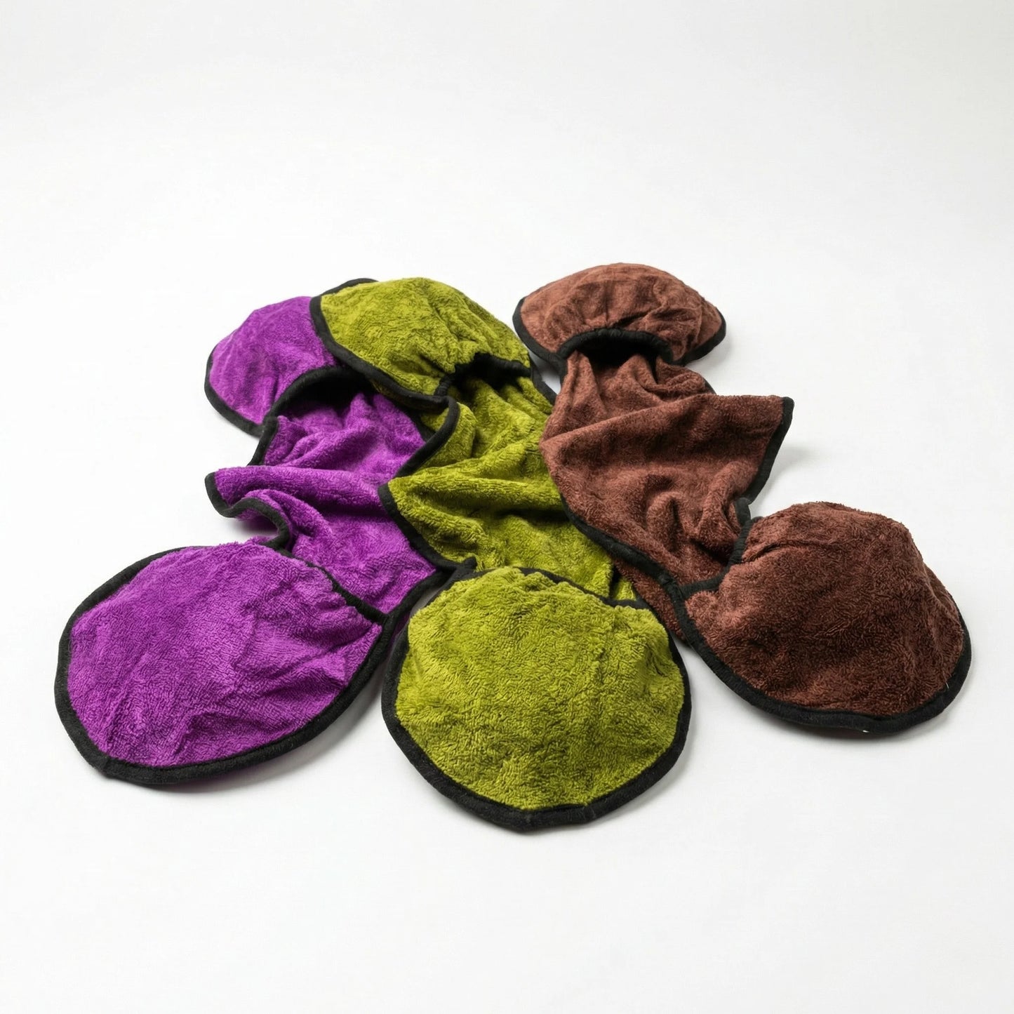 set of colour dog drying mitts made from bamboo material on white background