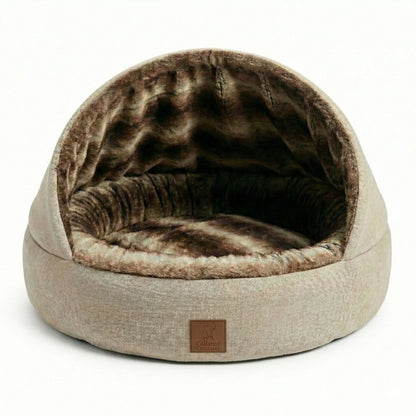 Round hooded pet bed with brown interior and beige exterior on a white background