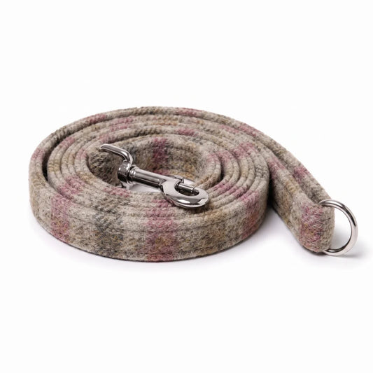 A coiled woven dog leash with a silver metal swivel clasp and a silver metal ring, featuring a textured plaid pattern in beige, gray, and muted pink, on a white background.
