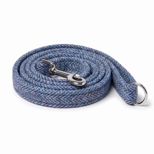 A coiled blue and gray herringbone woven strap with silver metal hardware, including a snap hook and a D-ring, shown on a plain white background.