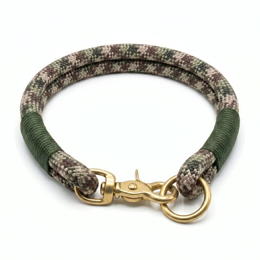 Camouflage-patterned dog collar with gold clasp on a white background