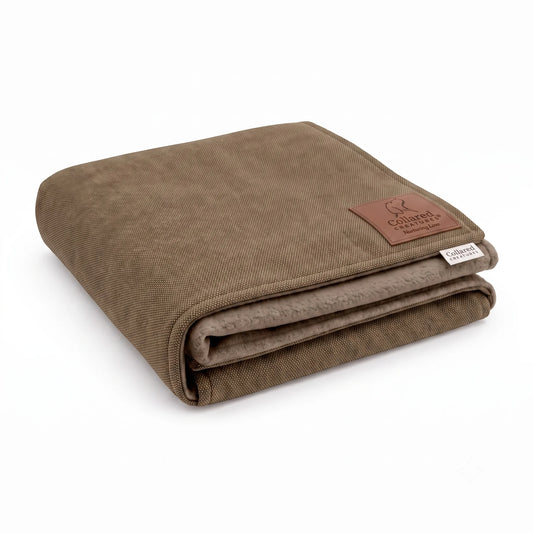 Collared Creatures taupe mocha woven dog blanket, folded to show soft taupe fleece lining and brown leather Nurturing Love patch