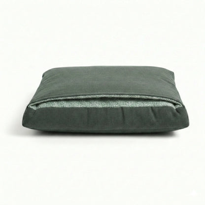 Green pillow dog bed with attached hood on a white background