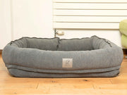 Front view of Collared Creatures bolster dog bed with hood fully removed and high sides visible