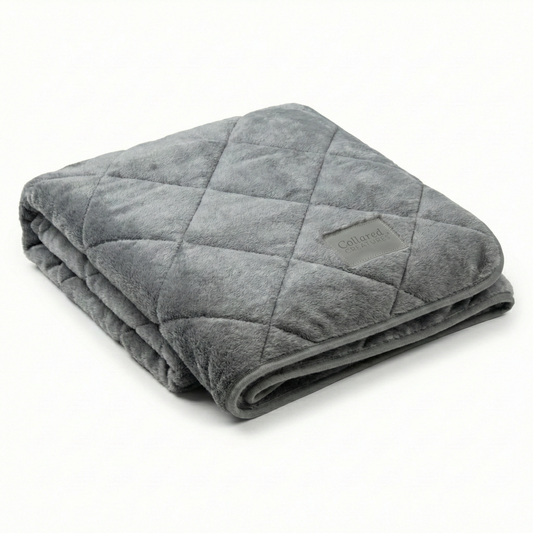Folded gray weighted blanket on a white background