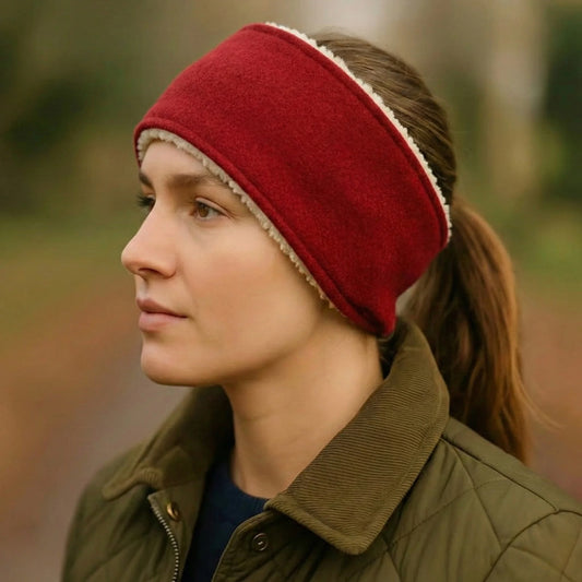 Person wearing a red harris tweed headband and green jacket outdoors