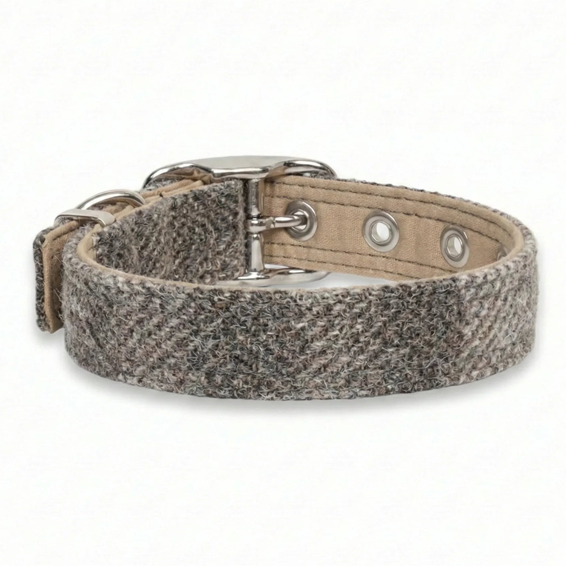 Dog collar with a textured fabric strap and metal buckle on a white background
