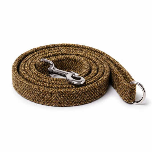 A coiled brown and beige herringbone woven dog leash with a silver metal snap hook and a silver metal ring, shown on a white background.