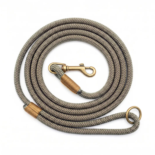 A coiled braided rope lead in a country green color with antique bronze metal hardware, including a snap hook, ring, and wrapped ferrule, shown on a plain white background.