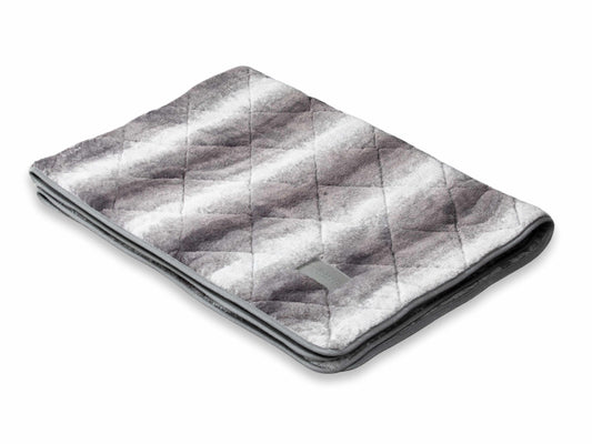 Folded luxury grey faux fur dog blanket with quilted design on white background