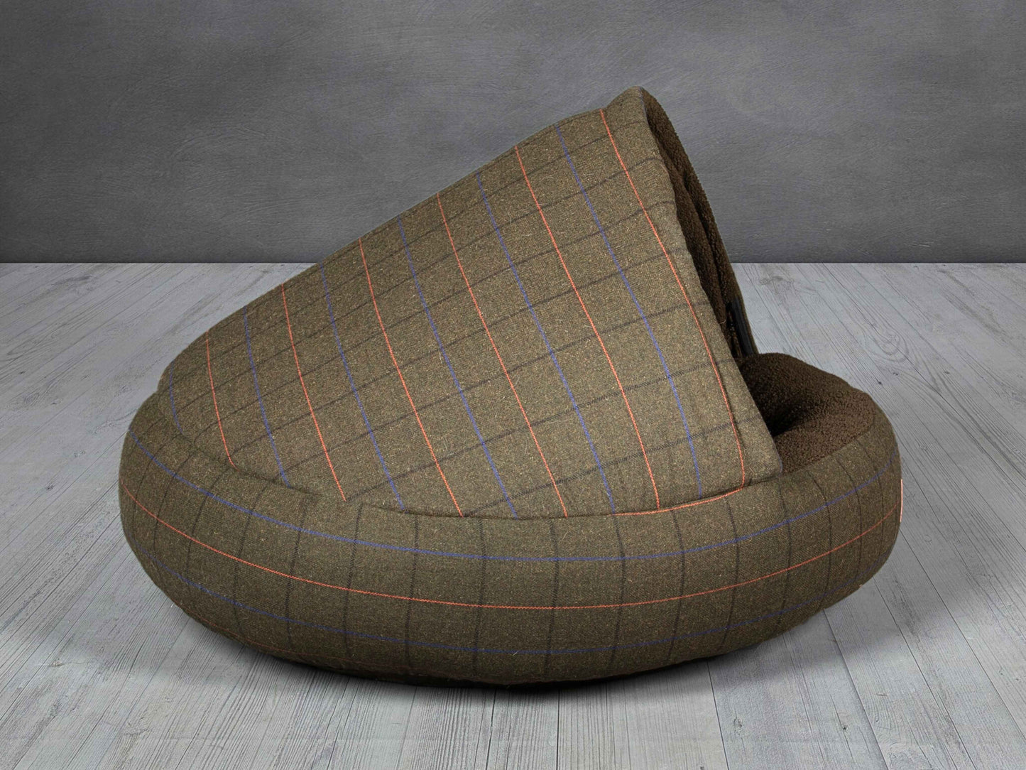Side view of the Green Tweed Cocoon Dog Bed against grey background, highlighting the plush hood.