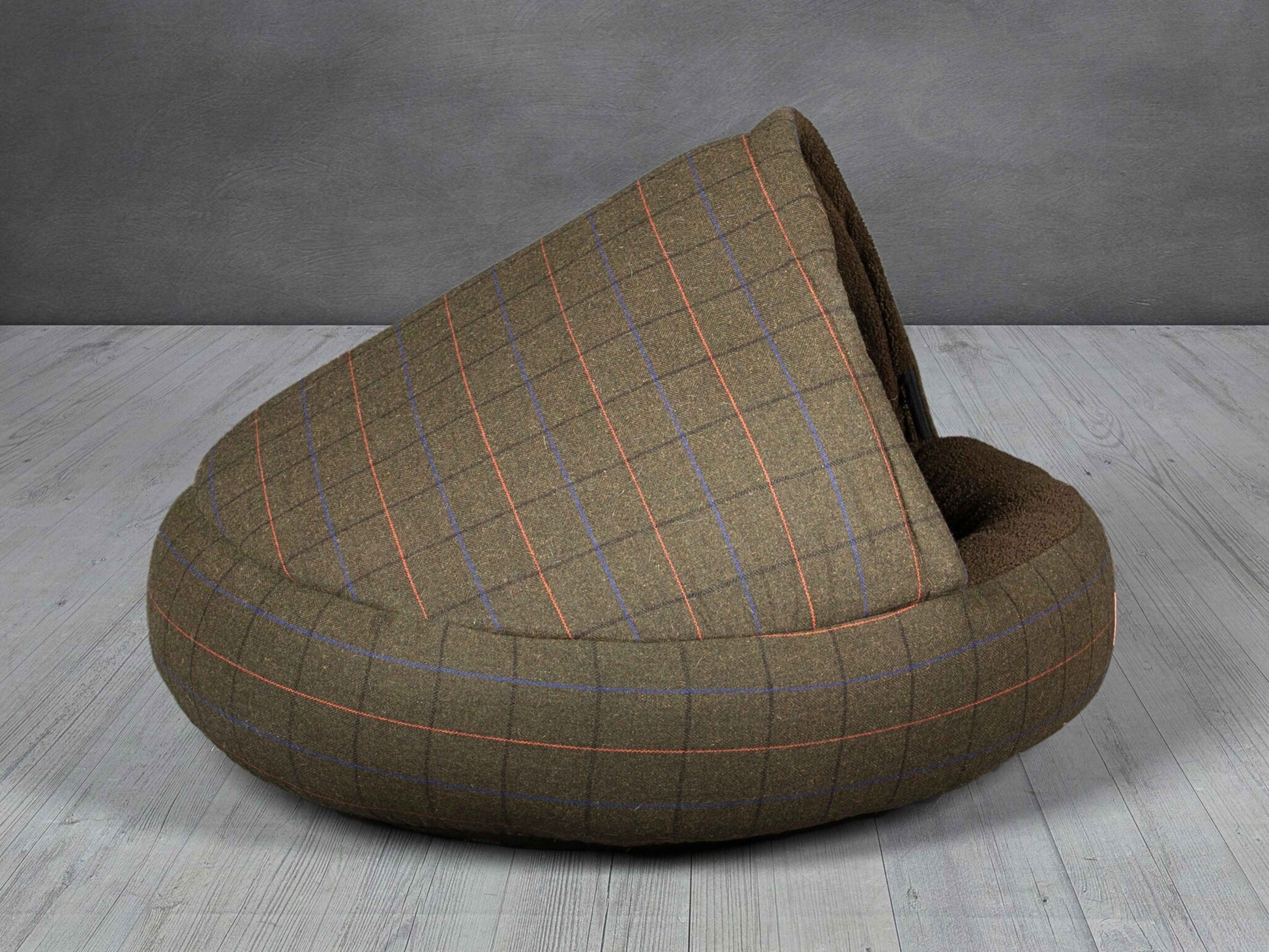 Side view of the Green Tweed Cocoon Dog Bed against grey background, highlighting the plush hood.