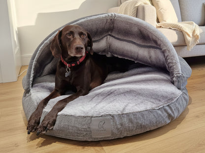 dog snuggled in collared creatures grey cave bed with faux fur interior